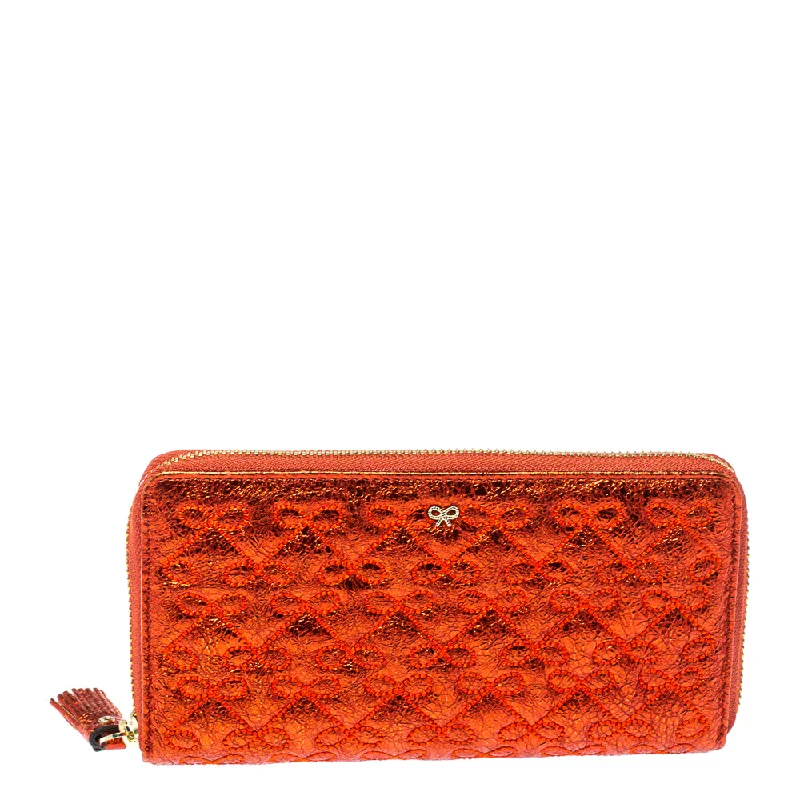 Women's money clip for the modern bohemian style​Anya Hindmarch Metallic Orange Textured Embossed Leather Zip Around Wallet