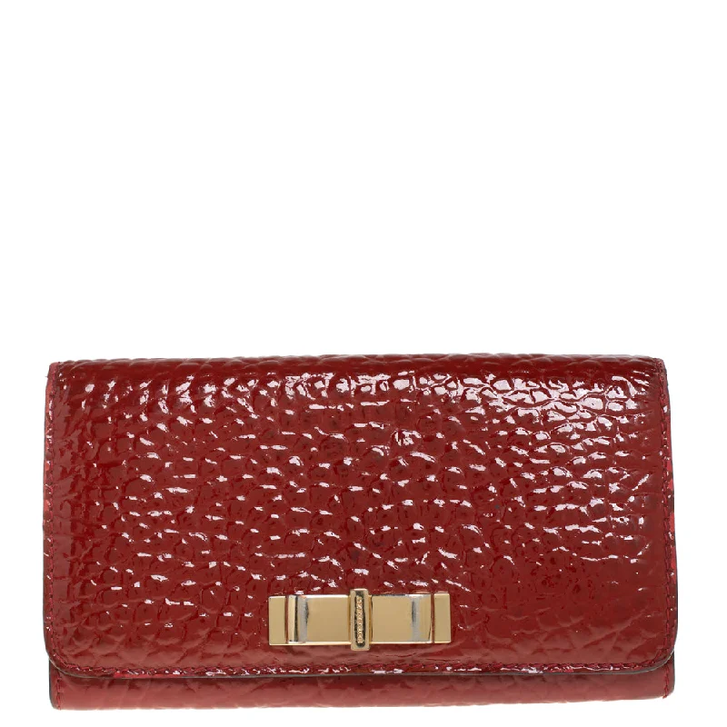 Women's money clip with a braided leather strap​Burberry Red Embossed Patent Leather Penrose Continental Wallet..