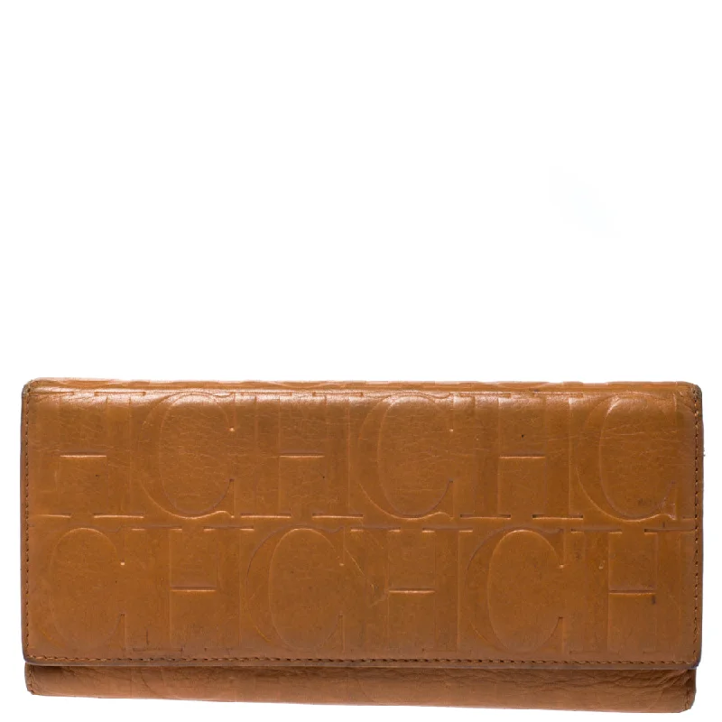 Women's money clip for a sporty - chic outfit​Ch Carolina Herrera Mustard Monogram Embossed Leather Trifold Continental Wallet..