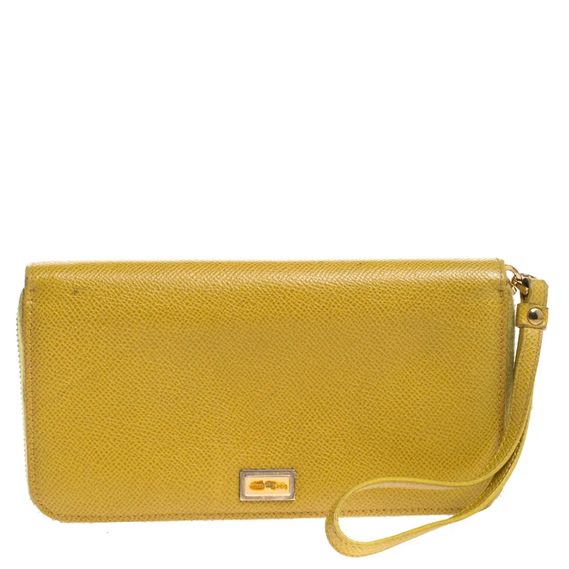 Women's money clip with a faux fur trim​Dolce & Gabbana Paglia Yellow Leather Strappy Zip Around Wallet..