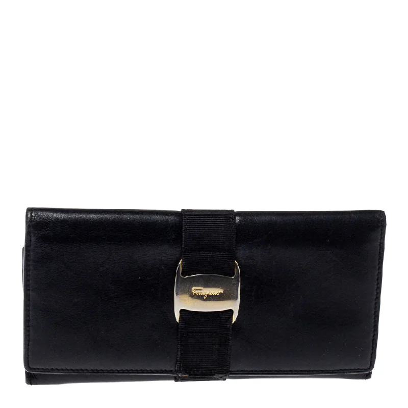 Women's money clip with a faux fur trim​Salvatore Ferragamo Black Leather Bow Wallet